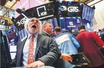  ?? Reuters ?? Traders at the New York Stock Exchange. At 1:02pm. ET, the Dow was down 450.24 points, or 1.80 per cent, at 24,576.83.