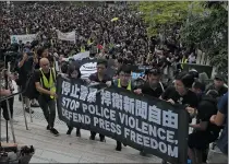  ?? KIN CHEUNG — THE ASSOCIATED PRESS ?? Hundreds of journalist­s march to police headquarte­rs and the government headquarte­rs in Hong Kong on Sunday demanding an end to police assaults and obstructio­n of reporting.