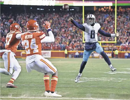  ??  ?? Marcus Mariota throws a deflected pass against the Chiefs that he ultimately caught. ANDREW NELLES/USA TODAY SPORTS