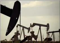  ?? CHARLIE RIEDEL — THE ASSOCIATED PRESS, FILE ?? Pumpjacks work in a field near Lovington, N.M., on April 24, 2015. In the closing months of the Trump administra­tion, energy companies stockpiled enough drilling permits for western public lands to keep pumping oil for years.