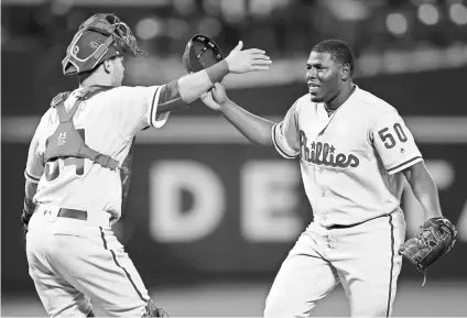  ?? BRAD PENNER, USA TODAY SPORTS ?? Phillies relief pitcher Hector Neris celebrates the first of his back-to-back saves against the Braves with catcher Andrew Knapp on April 20.