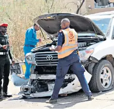  ??  ?? Sudanese police examine Abdalla Hamdok’s wrecked motorcade after the explosion