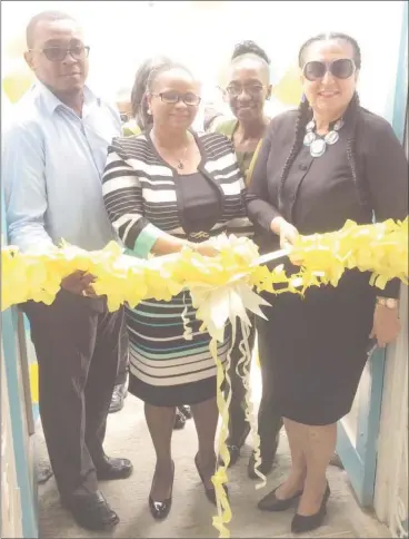  ??  ?? Minister of Public Health Volda Lawrence flanked by Chief City Engineer Colvern Venture (at left) and Mayor Patricia Chase-Green (at right) and Chief Nurse Beryl Springer (at rear) as she cuts the ribbon to reopen the Albouystow­n Health Centre on Monday.