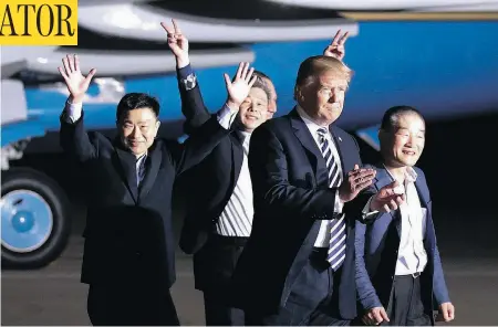  ?? ALEX BRANDON / THE ASSOCIATED PRESS ?? U.S. President Donald Trump walks with former North Korean detainees Tony Kim, Kim Hak-song and Kim Dong-chul at Andrews Air Force Base, Md.