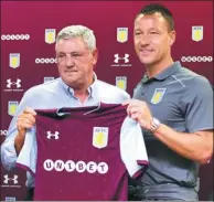  ?? AARON CHOWN/PA VIA AP ?? New Aston Villa signing John Terry (right) poses with manager Steve Bruce during Monday’s media conference in Birmingham, England.