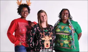  ?? AMY DAVIS, TNS ?? From left, Dia Jennifer Eisenberg and Keisha Jones show off their “ugly” Christmas sweaters.