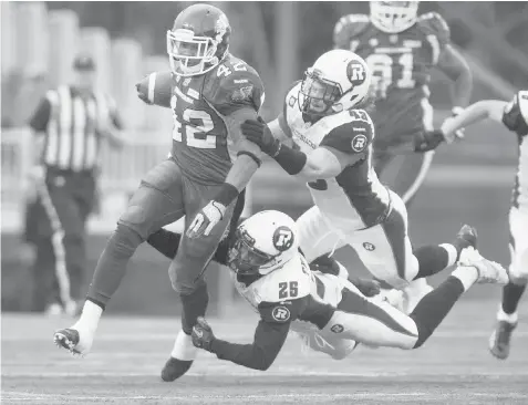  ?? LIAM RICHARDS/The Canadian Press ?? Saskatchew­an running back Keith Toston breaks away from Ottawa linebacker Anton McKenzie and defensive back Brandyn Thompson for a few extra
yards on Sunday. The CFL expansion Redblacks, playing their first game ever, dropped a 21-17 decision to the...