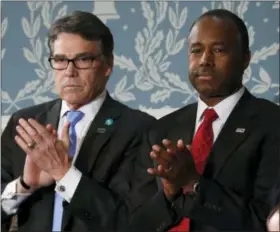  ?? THE ASSOCIATED PRESS ?? Energy Secretary Rick Perry, left, and Housing and Urban Developmen­t Secretaryd­esignate Ben Carson applaud on Capitol Hill in Washington, Tuesday, Feb. 28, 2017, before President Donald Trump’s address to a joint session of Congress.