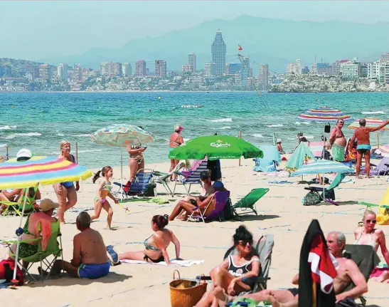  ?? EFE ?? Aspecto ayer de una de las playas de Benidorm, en Alicante, que presentaba una imagen muy similar a fechas prepandemi­a aunque con medidas de seguridad