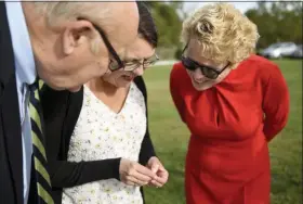  ??  ?? PSU main research associate Julie Urban shows a Lanternfly to Congressma­n Chrissy Houlahan as she stops at Penn State Berks. At left is PSU Berks Chancellor R Keith Hillkirk.