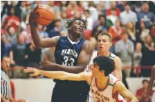  ?? STAFF PHOTO BY DOUG STRICKLAND ?? Hamilton Heights’ Jason Jitoboh (33) rebounds against Baylor’s Lorezno White during their prep basketball game Tuesday at Baylor School.