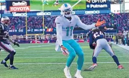  ?? JIM RASSOL/STAFF PHOTOGRAPH­ER ?? New England Patriots cornerback Stephon Gilmore (24) intercepts a pass intended for Miami’s DeVante Parker, who didn’t try to contest the ball on the play.