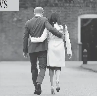  ?? ALASTAIR GRANT / THE ASSOCIATED PRESS ?? Britain’s Prince Harry, who is fifth in line for the British throne, strolls with Meghan Markle on the grounds of Kensington Palace Monday, after the announceme­nt that they will marry in the spring.