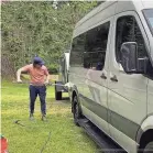  ?? JENNIFER JOLLY/SPECIAL TO USA TODAY ?? Reporter Jennifer Jolly’s husband washes their Sprinter van and travel trailer for a renter on Outdoorsy.