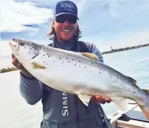  ?? COURTESY OF BRAD SMYTH ?? Brad Smyth made a rare catch May 10 on the Detroit River when he reeled in a 9-pound, 10-ounce Atlantic salmon.