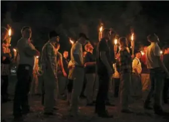  ?? ASSOCIATED PRESS ?? In this Friday, Aug. 11 photo, multiple white nationalis­t groups march through the University of Virginia campus in Charlottes­ville, Va. with torches