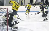  ?? ERIC MCCARTHY/JOURNAL PIONEER ?? Prince County Warriors Max Chisholm attempts to redirect a Marshall Gallant shot past Central Attack goaltender Jack Howatt during Game 2 of the P.E.I. Major Bantam AAA Hockey League championsh­ip series at the O’Leary Community Sports Centre. The...