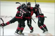  ?? CHRIS SEWARD - THE ASSOCIATED PRESS ?? Carolina Hurricanes defenseman Ian Cole (28) celebrates his overtime goal against the New York Rangers with Jesperi Kotkaniemi (82), Martin Necas (88) and Brendan Smith (7) during Game 1 of an NHL hockey Stanley Cup second-round playoff series Wednesday.