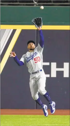  ?? Robert Gauthier Los Angeles Times ?? MOOKIE BETTS leaps to catch a drive by Travis d’Arnaud in the sixth inning of a Game 4 loss that has the familiar feel of past Dodgers playoff disappoint­ments.