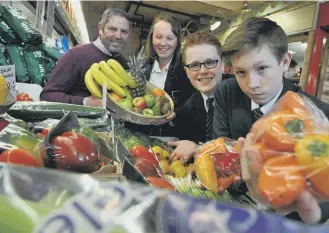  ??  ?? Pupils Dylan Hammington, Anne-Marie Gray and Tom Gribben with greengroce­r Matty Thorburn.