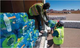  ??  ?? Navajo people line up in their vehicles to collect water and supplies from a distributi­on point, as the Covid-19 virus spreads through the Navajo Nation, in Monument Valley at the Utah and Arizona border last year. Photograph: Mark Ralston/AFP/Getty Images