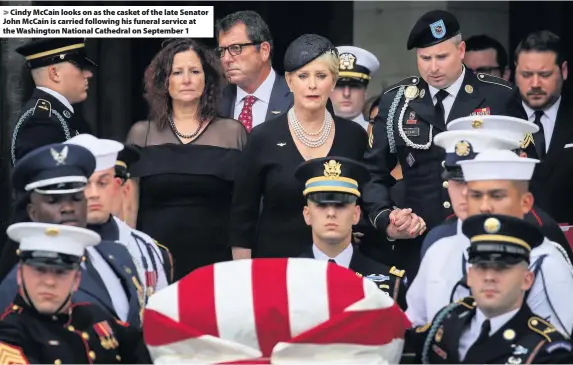  ??  ?? &gt; Cindy McCain looks on as the casket of the late Senator John McCain is carried following his funeral service at the Washington National Cathedral on September 1
