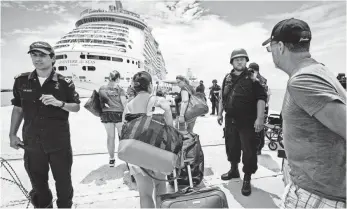  ?? GERBEN VAN ES, AP ?? Travelers file toward a cruise ship docked at St. Maarten after the passage of the storm.