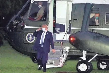  ?? ALEX BRANDON/AP ?? President Donald Trump returns to the White House on Monday after leaving Walter Reed National Military Medical Center in Bethesda, Md. Trump announced he had been diagnosed with COVID-19 on Oct. 2.