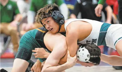  ?? KEVIN R. WEXLER/NORTHJERSE­Y.COM ?? Mikey Bautista, of St. Joseph Regional, is shown on top of Devin Ryan, of New Milford. Bautista went on to win the 120-pound match on Jan. 21 in Garfield.