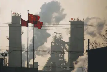  ??  ?? Chinese national flags are flying near a steel factory in Wu’an, Hebei province, China, February 23, 2017.