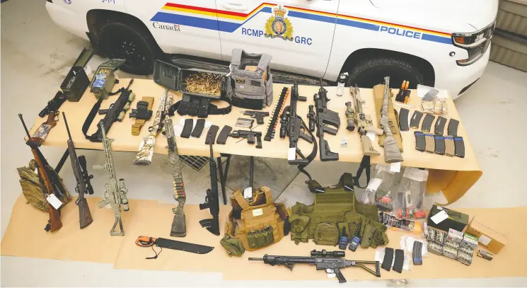  ?? RCMP ?? Mounties executed a search warrant Monday on three trailers at the Coutts blockade, finding 13 long guns, multiple sets of body armour,
a machete, a large quantity of ammunition and high capacity magazines.