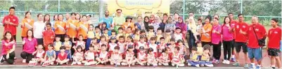  ??  ?? Frankie (in green T-Shirt) with Taren Sunil, officials, parents, coaches and kids at launch of free tennis coaching.