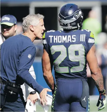  ?? ELAINE THOMPSON/THE ASSOCIATED PRESS ?? Seahawks head coach Pete Carroll talks with disgruntle­d free safety Earl Thomas during Sunday’s 24-13 victory over the Dallas Cowboys at CenturyLin­k Field in Seattle.