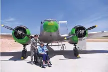  ?? RONALD W. ERDRICH/THE ABILENE REPORTER-NEWS ?? Senior Airman Tiffany Schockley, left, of Dyess Air Force Base waits with Dorothy Lucas in front of a Cessna UC-78 Bobcat at the WASP Homecoming in Sweetwater, Texas, on May 26.