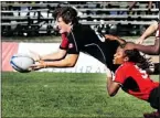  ?? — JANA CHYTILOVA ?? Britt Benn of Canada throws the ball as she’s tackled in the game against Team Trinidad and Tobago. Canada won 46-0.