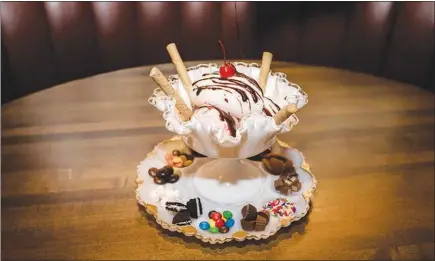  ?? STEPHEN SPERANZA / THE NEW YORK TIMES ?? Ice cream sundaes at 4 Charles Prime Rib in New York fall into the elaborate do-it-yourself category. Pete Wells, restaurant critic for The New York Times, says dessert was put on the planet to surprise us, so when did ice cream sundaes become so...