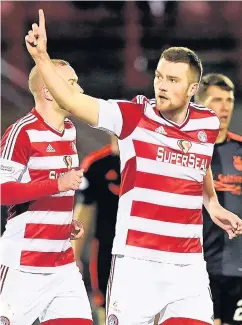  ??  ?? Fan-tastic Michael Devlin enjoys the cheers of the crowd after netting the winner against Dons