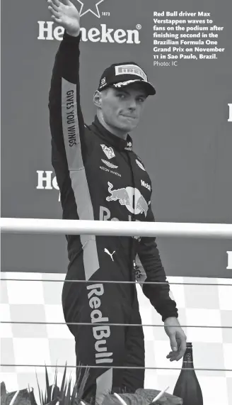  ?? Photo: IC ?? Red Bull driver Max Verstappen waves to fans on the podium after finishing second in the Brazilian Formula One Grand Prix on November 11 in Sao Paulo, Brazil.