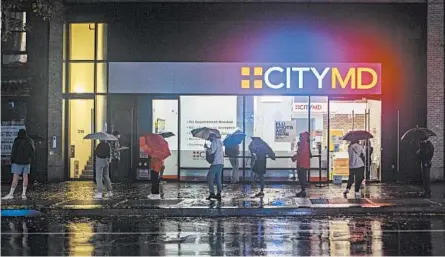  ?? HIROKO MASUIKE/THE NEW YORK TIMES ?? As the world hopes for an effective coronaviru­s vaccine, people await testing last week outside CityMD in New York City.