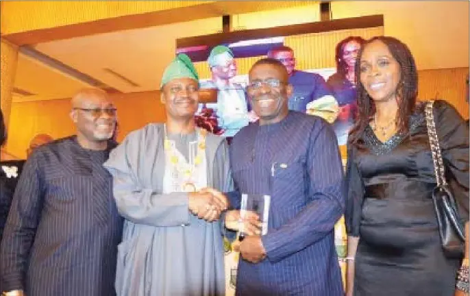  ??  ?? BoI Acting Managing Director/CEO, Mr. Waheed Olagunju (second from right), receiving the ICAN merit award from the President of the Institute of Chartered Accountant­s of Nigeria, Deacon Titus A. Soetan, FCA, in recognitio­n of BoI’s outstandin­g...