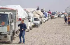  ?? — AFP ?? Displaced Iraqis, who fled from Hawija to Kirkuk due to battles against the IS group, return to their hometown.