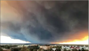  ?? DAVID LITTLE/CHICO ENTERPRISE-RECORD VIA AP ?? The massive plume from the Camp Fire, burning in the Feather River Canyon near Paradise, Calif., wafts over the Sacramento Valley as seen from Chico, Calif., on Thursday.