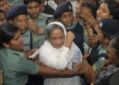  ?? Abu Taher Khokon/Associated Press ?? Police escort former Bangladesh­i Prime Minister and Awami League President Sheikh Hasina, center, to a court after she was arrested on extortion charges in Dhaka, Bangladesh, in July 2007.