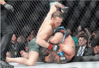  ?? JOHN LOCHER THE ASSOCIATED PRESS ?? Conor McGregor, left, fights Donald “Cowboy” Cerrone at UFC 246 on Saturday in Las Vegas.