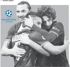  ??  ?? Paris Saint Germain’s Marquinhos (centre) celebrates after scoring with Zlatan Ibrahimovi­c (left) and Adrien Rabiot during the UEFA Champions League last 16 second-leg match against Bayer Leverkusen in Paris. — AFP photo