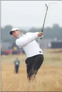  ?? The Associated Press ?? Rory McIlroy plays out of the rough on the second hole during the second round of the British Open on Friday.