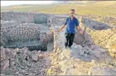  ?? AFP ?? A man inspects a site at the ancient city of Qalatga Darband, believed to have been founded by Alexander the Great.