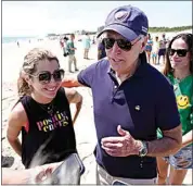  ?? MANUEL BALCE CENETA / AP ?? President Joe Biden talks to the media after walking on the beach with his granddaugh­ter Natalie Biden, left, and his daughter Ashley Biden, right on Monday at Rehoboth Beach, Del.
