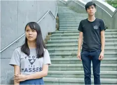  ?? — AFP photo ?? Chow (left) and Shum pose for photos outside the Hong Kong government headquarte­rs.