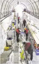  ?? NANCY BERTLER/AP ?? Scientists and staff work on ice cores they’ve collected Nov. 22 on Roosevelt Island, Antarctica. The ice provides clues for scientists studying the effects of climate change.